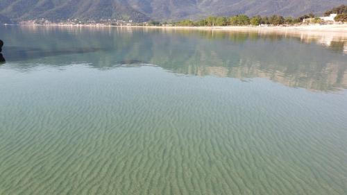 a large body of water with mountains in the background at Studios Tasos in Chrysi Ammoudia