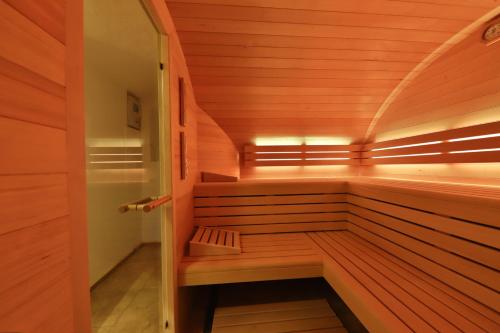 a sauna with a bench in a wooden room at Locations des 3 sommets avec Sauna et Spa en Alsace in Sondernach