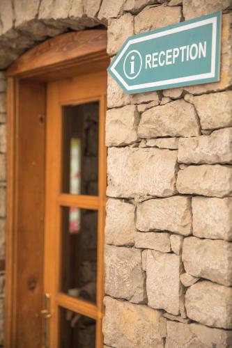 a street sign on the side of a stone building at Mosaic Home in Tirana