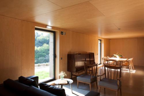 a living room with a couch and a table at Melgaço Alvarinho Houses in Melgaço