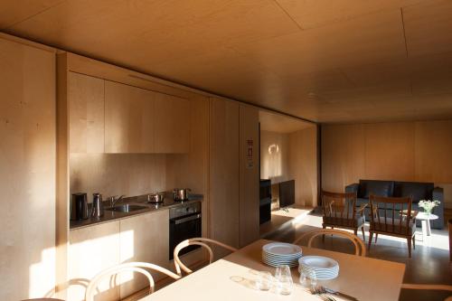 a kitchen and dining room with a table and chairs at Melgaço Alvarinho Houses in Melgaço