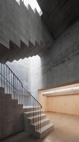a staircase in a building with a concrete wall at Melgaço Alvarinho Houses in Melgaço