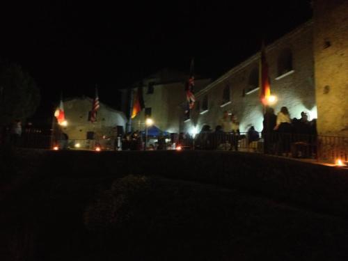 a group of people standing outside of a building at night at Agriturismo L'Antico Casale in Altomonte