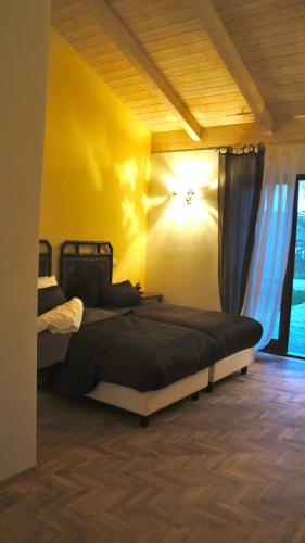 a bedroom with a bed and a yellow wall at Taverna Centomani in Potenza