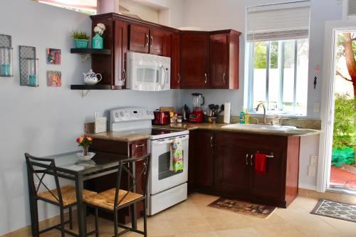a kitchen with wooden cabinets and a white stove top oven at Sweet Dreams B&B LA in Sherman Oaks