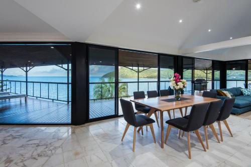 a dining room with a table and chairs at Mermaids Reach on Hamilton Island by HIHA in Hamilton Island