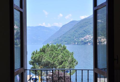 a view of a lake from a window at Hotel Ristorante Vapore in Faggeto Lario 