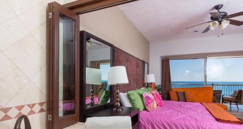 a bedroom with a pink bed and a mirror at Sonoran Sky 3BR 1202 UpperSkyby Casago in Puerto Peñasco