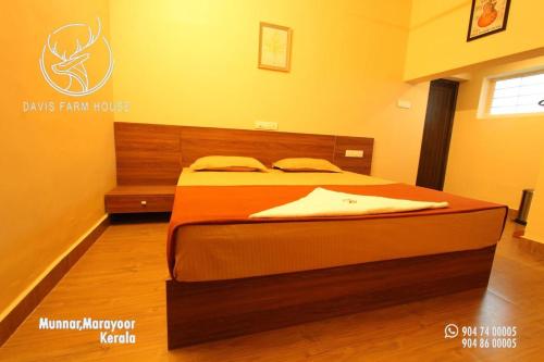 a bedroom with a large bed in a room at Davis Farm House in Marayoor