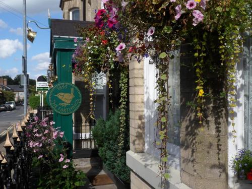 a building with flowers on the side of it at The Farthings in York
