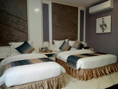 a hotel room with two beds in a room at V Boutique Hotel in Phnom Penh
