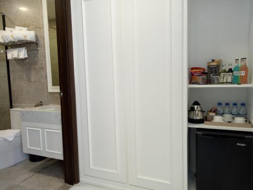 a bathroom with a sink and a white cabinet at V Boutique Hotel in Phnom Penh