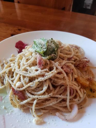 a plate of pasta with pesto on a table at White Summerville Tourist Inn in Busuanga