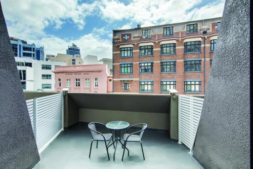 
a room with a table and chairs and a building at Central Studio Hotel Sydney in Sydney
