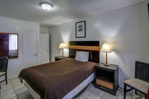 a hotel room with a bed and a chair at Richard's Hotel in Hollywood