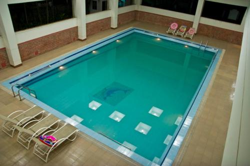 a swimming pool with a blue floor and blue walls at Nirvana Inn in Sylhet