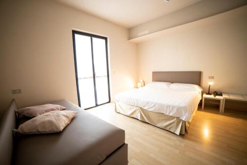 Un ou plusieurs lits dans un hébergement de l'établissement Hotel Miranda