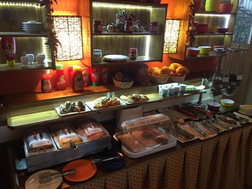 a buffet with many different types of food on display at Hotel Balaton Fonyód in Fonyód