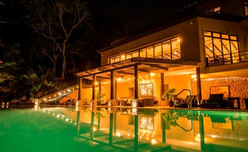 a house with a swimming pool at night at Las Lagunas Boutique Hotel in Flores