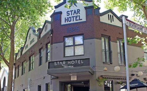 a large building with a sign on the side of it at The Star Apartments in Newcastle