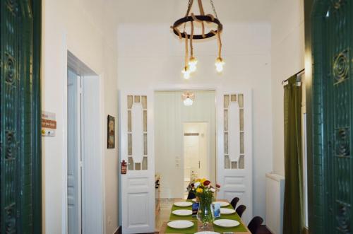 a dining room with a table with flowers on it at Neoclassical House with Unique Athenian Yard (nearby metro station) in Athens