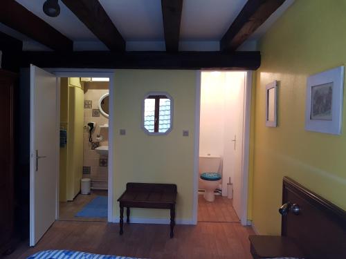 a hallway with a toilet and a stool in a room at Au Cep de Vigne in Riquewihr