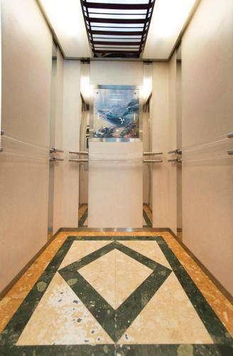 a hallway with a tiled floor in a museum at Siam Palace Hotel in Bangkok