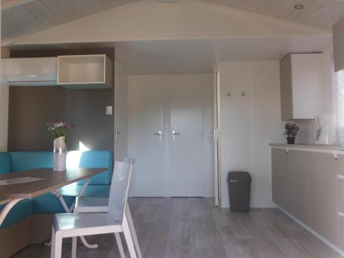 a kitchen and dining room with a table and chairs at Camping l'Eléphant in Saint-Raphaël