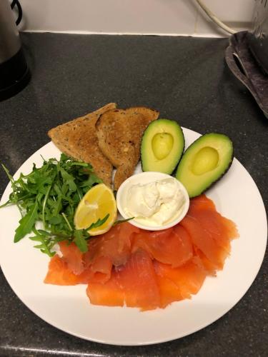 a plate of food with an egg avocado toast and smoked salmon at Elmdon Lodge in Birmingham
