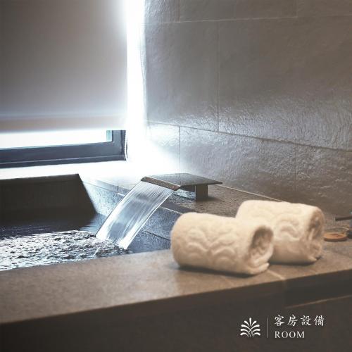 a white towel on a counter in a bathroom at Hotel Royal Beitou in Taipei