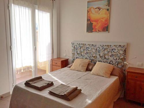 a bedroom with a bed with two towels on it at Apartamento Tania - El Toyo - Cabo de Gata in Retamar