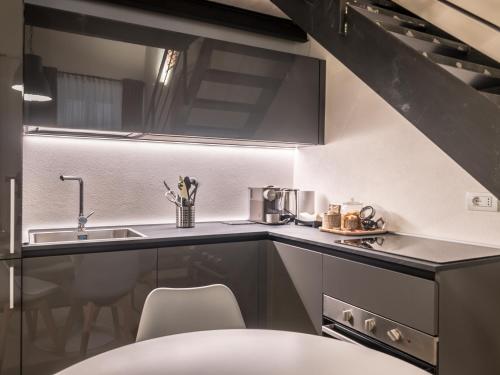 a kitchen with a sink and a counter top at My Luxury Suites - Standard in Savona