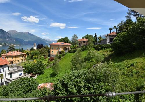 a group of houses on a green hill with a lake at La Piccola Bellagio in Bellagio