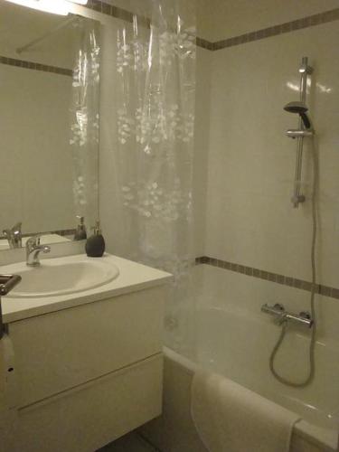 une salle de bain avec un lavabo, une baignoire et une douche dans l'établissement Acapulco Frejus Plage, à Fréjus