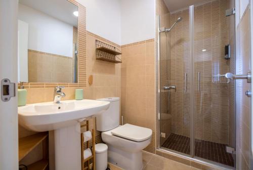 a bathroom with a toilet and a sink and a shower at Santa Marina Central Loft by Valcambre in Seville