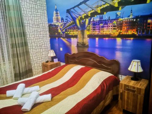 a bedroom with a bed with a view of a bridge at Hostel Sadu Kutaisi in Kutaisi