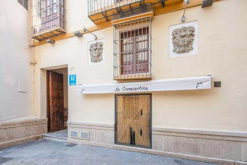 a building with a sign on the side of it at CASA MIRAFLORES in Málaga