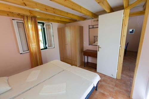 a bedroom with a white bed in a room at FOUFAS HOUSES in Paralion astros