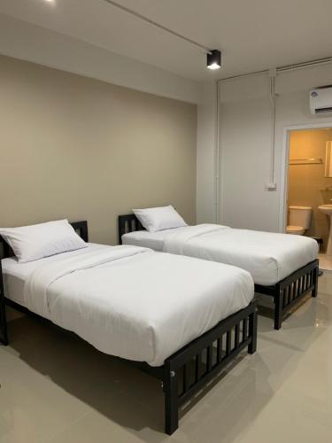 two beds sitting next to each other in a room at 9TY hotel (ninety hotel) in Bangkok