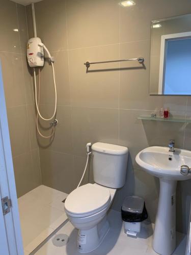 a bathroom with a toilet and a sink at 9TY hotel (ninety hotel) in Bangkok