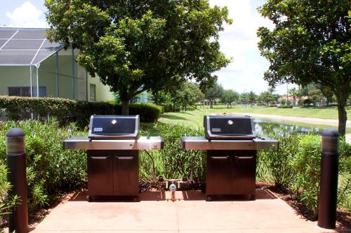 two tables with laptops on them on a sidewalk at Summer Bay Orlando by Exploria Resorts in Orlando