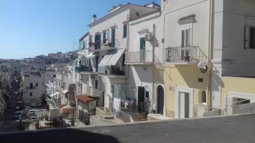 a group of white buildings with balconies on them at Suite mozart in Vieste