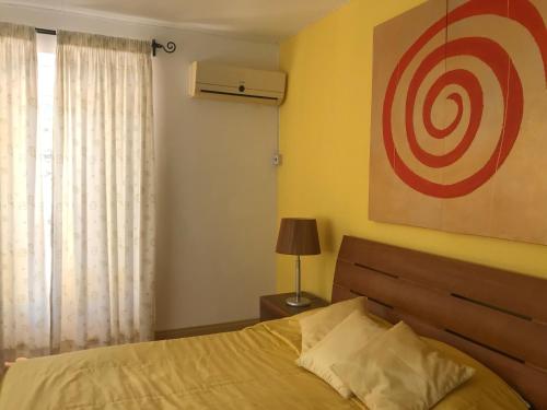 a bedroom with a bed with a target on the wall at Oceanpride Complex in Flic-en-Flac
