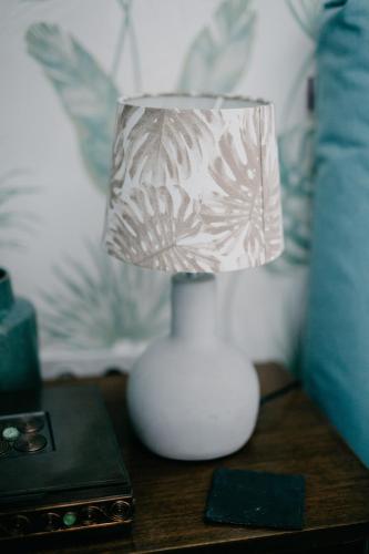 a white lamp sitting on top of a table at JAM Luxury Apartment in Győr