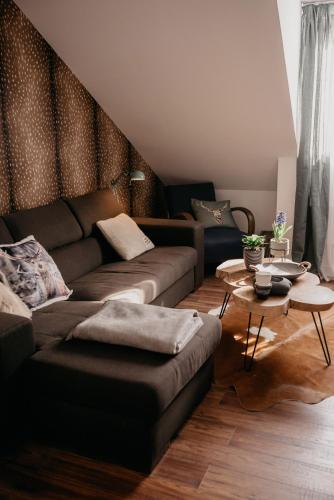 a living room with a couch and a table at JAM Luxury Apartment in Győr