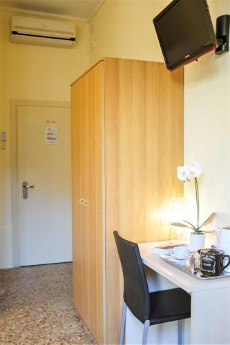 a room with a desk with a chair and a tv at Hotel Santa Lucia in Venice