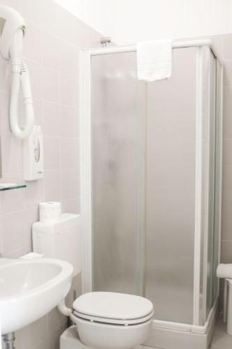 a bathroom with a shower and a toilet and a sink at Hotel Santa Lucia in Venice