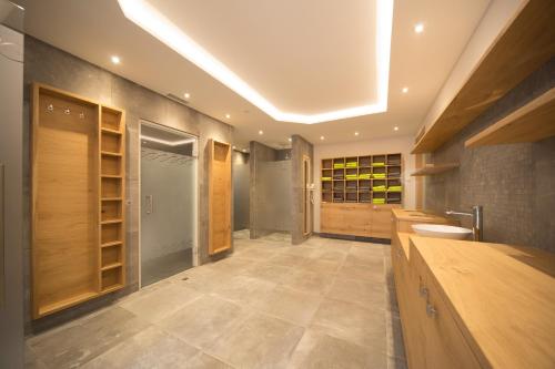 a large bathroom with wooden cabinets and a sink at Hotel Stadler am Attersee in Unterach am Attersee