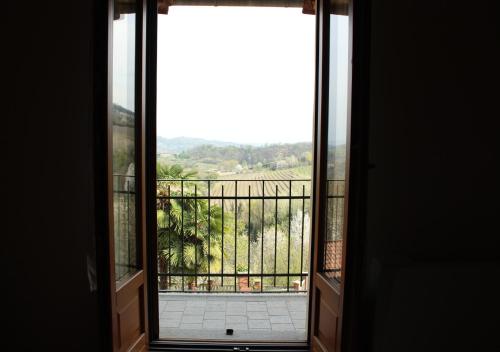 an open door to a balcony with a view at Ca d'Pinin in Albugnano 