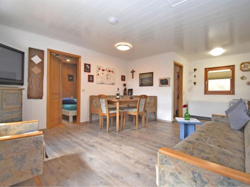 a living room with a table and a couch at Holiday home with terrace in Stadlern